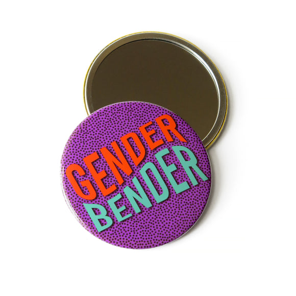 Two 3 inch round Pocket Mirrors. One showing the reflective side. The other side showing a purple with tiny black dots patterned background with the words GENDER BENDER in orange and light teal wavy text.