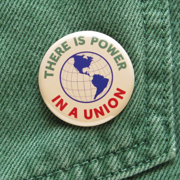 There is Power In a Union Pinback Button on green denim pocket.