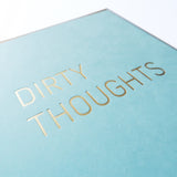 Light blue greeting card that says DIRTY THOUGHTS.  Close up of the hot foil pressed text.