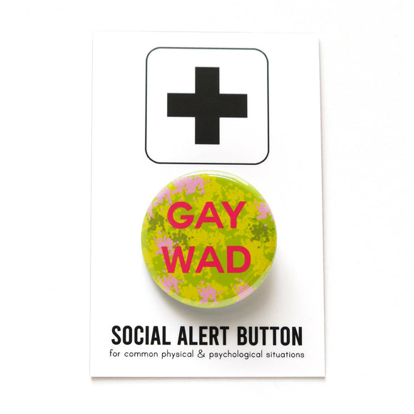 Round yellow green patterned pinback button that reads GAY WAD in dark pink text. Badge is on a Social Alert Button backing card.