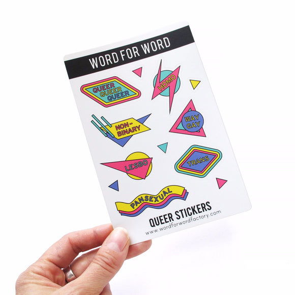 rectangle sticker sheet, portrait orientation, with 7 large brightly colored stickers, and 5 little triangles. The stickers have a retro 1980's design, reading QUEER, HOMO, NON-BINARY, WAY GAY, LESBO, TRANS, PANSEXUAL
