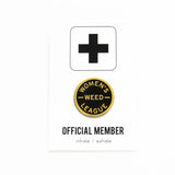 Round enamel pin that says WOMEN'S WEED LEAGUE, on a backing card that says Official Member.