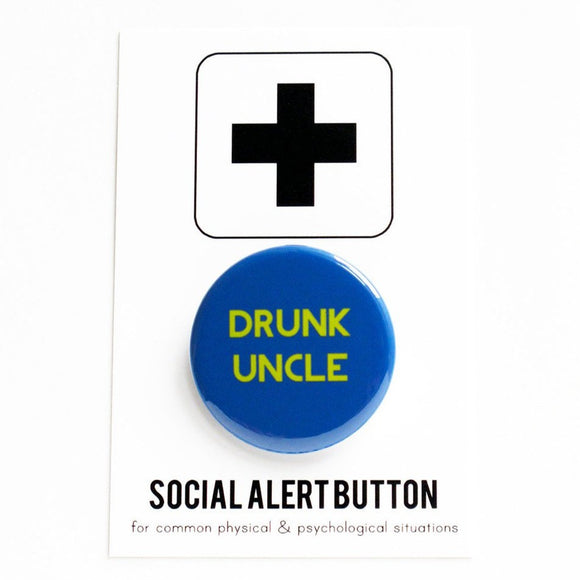 Round blue pinback button that reads DRUNK UNCLE in lime green text. The button is pinned to a Social Alert Button backing card.