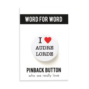 Round white pinback button that reads I Love Audre Lorde, with love indicated with a red heart. Button is on a Word for Word backing card.