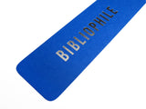 Close-up details shot of a deep bright blue vertical bookmark that reads BIBLIOPHILE in silver foil embossed text.