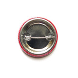 back of a red metal pinback button