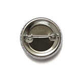 The backside of a metal pinback button