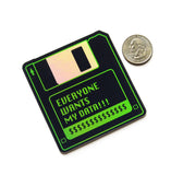 A black & green holographic sticker that look like a 1990's little hard floppy disc that reads EVERYONE WANTS MY DATA !!! with a strip of dollar signs where a label would be. A quarter sits next to the sticker for size comparison.