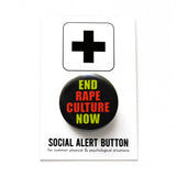 Round black pinback button that reads END RAPE CULTURE NOW in neon yellow and orange san serif text. The button is pinned to a Social Alert Button backing card.