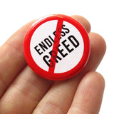 A round white button that reads ENDLESS GREEN in black text with a red circle and slash to indicate being against endless greed. Button badge is held in a hand.