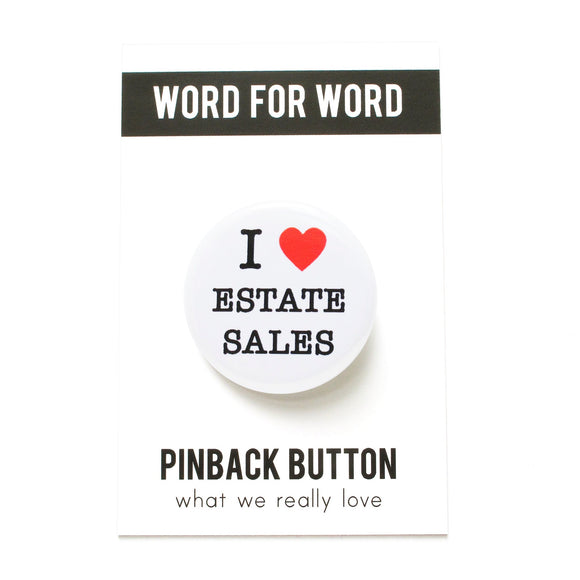 A round white pinback button that reads I LOVE ESTAET SALES with love being a red heart. On a Word for Word branded backing card, What We Really Love.