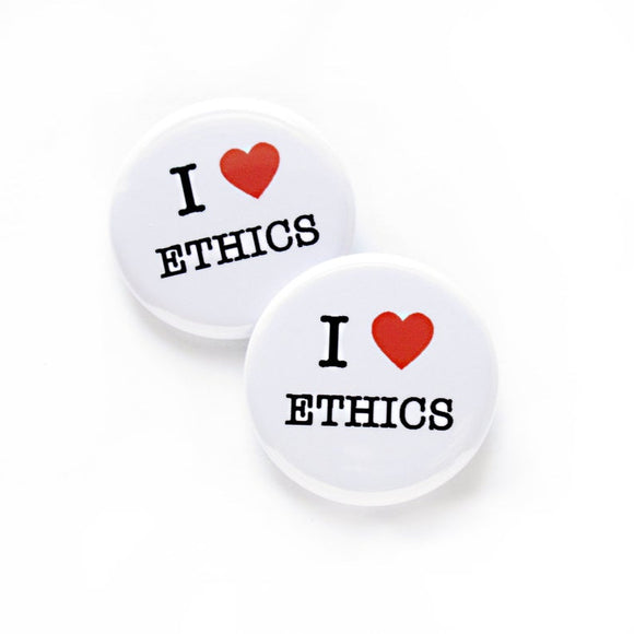 Two white round pinback buttons that reads I Love Ethics, love being a red heart. 