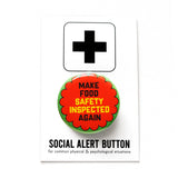 Round  & orange 1.25"  pinback button that reads MAKE FOOD SAFETY INSPECTED AGAIN in black and yellow text.  Pinback button is on a SOCIAL ALERT BUTTON backing card.