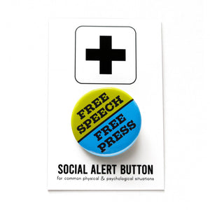 A round blue & lime green pinback button split down the middle. The green top half reads FREE SPEECH, the blue lower half reads FREE PRESS. Buton is held in a hand.