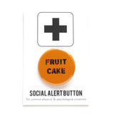 1.25" Round Social Alert Holiday Button. It has and orange background and text that says FRUIT CAKE on the button
