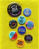 A colorful array of healthcare related pinback buttons on a neon yellow thermal shirt.
