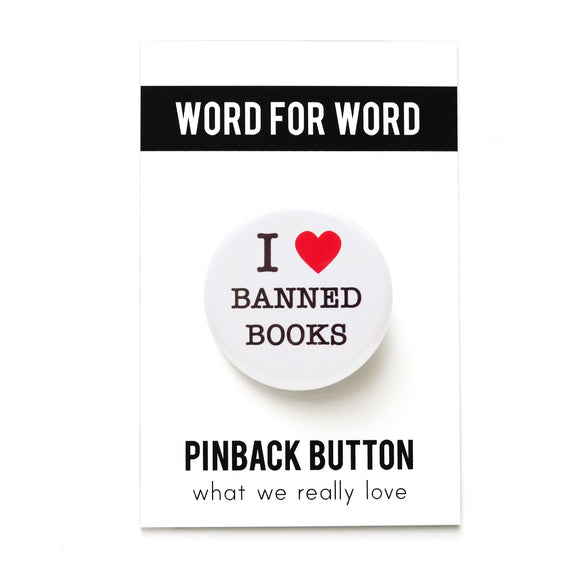 A round white pinback button that reads I LOVE BANNED BOOKS. Love represented by a red heart.