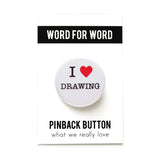 A round white pinback button that reads I LOVE DRAWING, love being represented by a red heart. Button is pinned to a Word For Word, What We Really Love branded backing card.