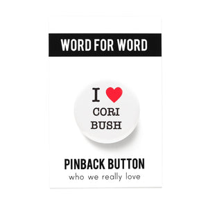 Round white pinback button on a white background that says I LOVE CORI BUSH. Love is depicted by a red heart. The other text is black.