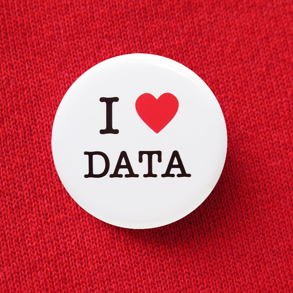 A round white button that reads I LOVE DATA with love being a red heart. Button is pinned to a red sweatshirt