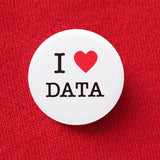 A round white button that reads I LOVE DATA with love being a red heart. Button is pinned to a red sweatshirt