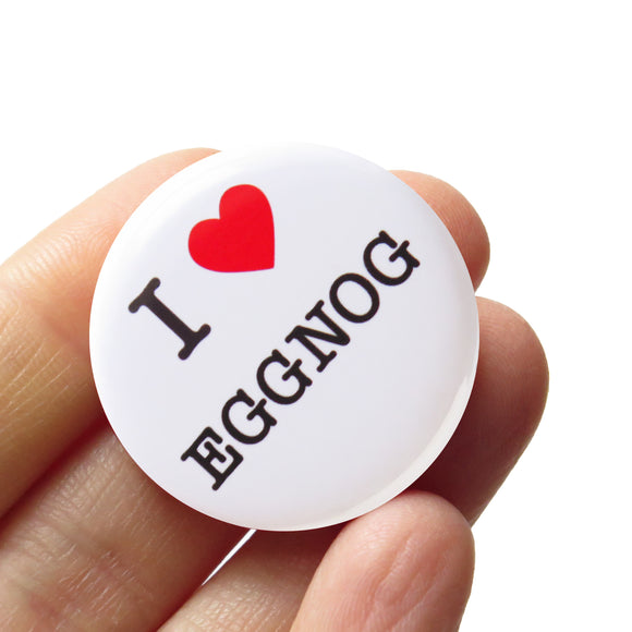 Round, white pinback button that says I LOVE EGGNOG in classic black text with 