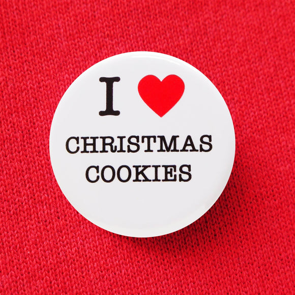 Round, white pinback button that says I LOVE CHRISTMAS COOKIES in classic black text with 