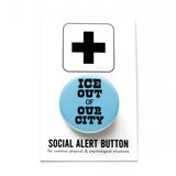 Round light blue pinback button that reads: ICE OUT of OUR CITY in chunky black text. The button is pinned to a Social Alert Button backing card.