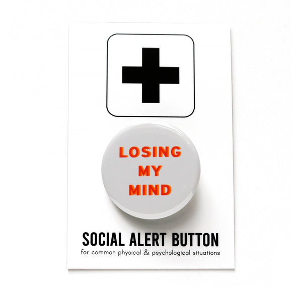 Round, light grey button with red & orange text reading LOSING MY MIND. Badge on a Social Alert Button backing card.