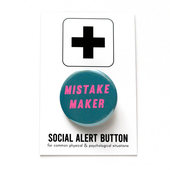 Round teal pinback button that reads MISTAKE MAKER in hot pink text. Badge is on a Social Alert Button backing card.