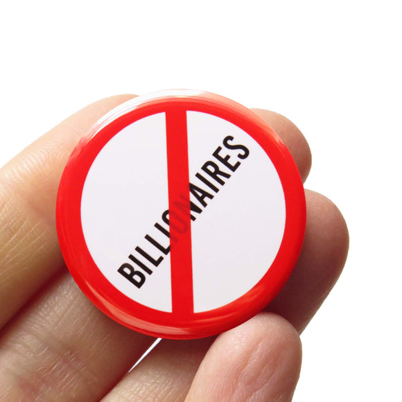 A round white button that reads NO BILLIONAIRES in black text with a red circle and slash to indicate being against billionaires. Button is held in a hand.