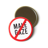 Product shot of 3" Round Pocket Mirror. The other side of the mirror has a white background with the words NO MALE GAZE in black writing, with a red no symbol negating the phrase.sh 