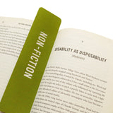 A rich mossy green vertical bookmark that reads NON-FICITON in gunmetal silver foil embossed text, marking the start of the Disability as Disposability (Ableism) in The Viral Underclass hardcover book.