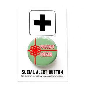 Round mint green pinback button with a bright red package bow and the words PRESENT PEEKER in white with a red outline text. Button is on a SOCIAL ALERT BUTTON Backing Card