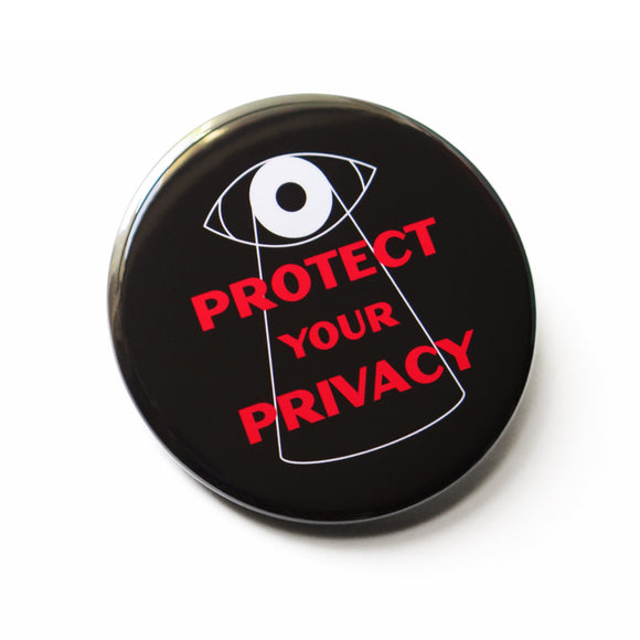 Round black pinback button that reads PROTECT YOUR PRIVACY in red text with a big brother overseer eye  overlooking the text with a white line outline.