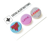Three round pinback buttons in various vintage 1980's styles on a SOCIAL ALERT BUTTONS backing card, laid at an angle. Buttons Left to Right: A blue button with a magenta triangle and gold text that reads POWER DYKE, A pink ombre button that reads SAPPHIC in a thin magenta pink font & a white button with tiny Memphis style black squiggles that reads LESBO in pink text with a Yellow drop shadow.