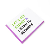 A horizontal white greeting card that reads LET'S GET STONED & LISTEN TO RECORDS in green, violet & black san serif text. Set with a violet purple envelope.
