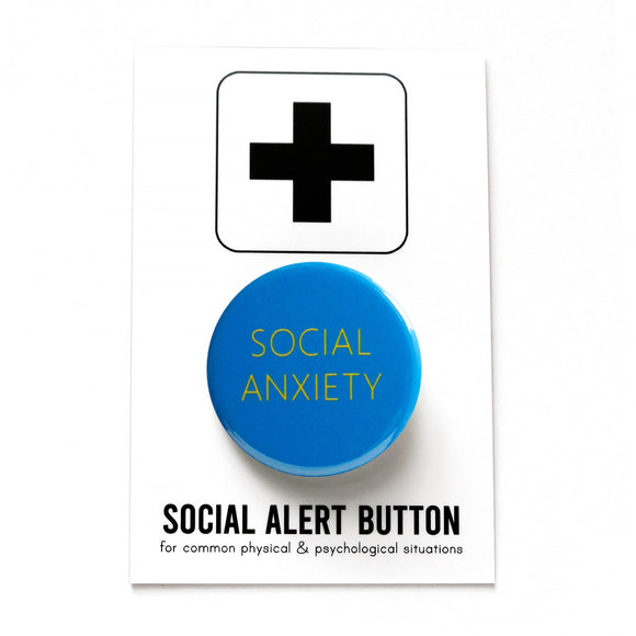 Round vibrant blue pinback button with very thin yellow text reading SOCIAL ANXIETY. Button is pinned to a Social Alert Button backing card.