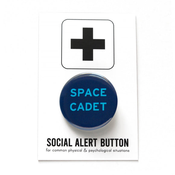 Round navy blue pinback button with vivid light blue text reading SPACE CADET. Pinned to a Social Alert Button backing card.