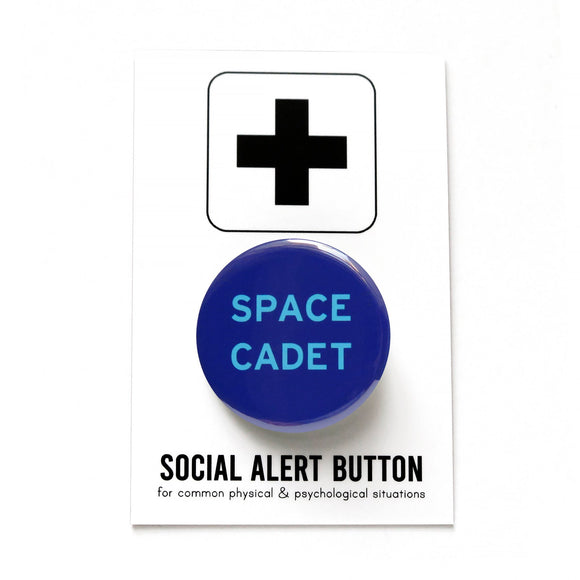 Round navy blue pinback button with vivid light blue text reading SPACE CADET. Pinned to a Social Alert Button backing card.