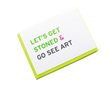 Smart Stoner Greeting Card, that reads LET'S GET STONED & GO SEE ART. White card with green, pink and black san serif text. Set with a neon green envelope.