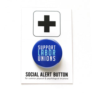 Dark blue round pinback button that reads Support Labor Unions in white & light blue text. Button is held in a hand.