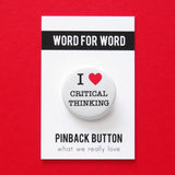 Round white pinback button that reads I LOVE CRITICAL THINKING, love being a red heart. Pinned to a Word For Word branded backing card, What We Really Love.