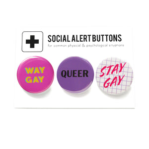 Three round pinback buttons on a Social Alert Buttons backing card. Buttons left to right: A dark Pink button that reads WAY GAY in yellow text, A purple button that reads QUEER in black text, and a 1980's style lavender grid button that reads STAY GAY in pink script.
