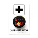 A round black pinback button that reads WEREWOLF in a spooky brown text with the O as a moon with a foggy cloud behind it. Button is on a Social Alert Button branded backing card.