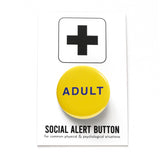 Round pinback button that says ADULT. Blue text on a yellow background. The button is pinned to a Social Alert Button backing card.