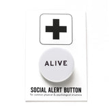 Round pinback button that says ALIVE. Black text on a white background. The button is pinned to a Social Alert Button backing card.