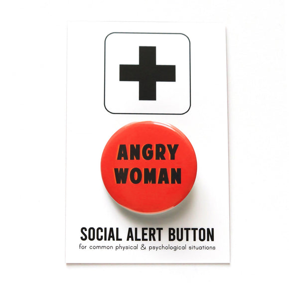 Round pinback button that says ANGRY WOMAN. Black text on a red background. Button is pinned to a Social Alert Button backing card