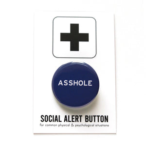 Round navy blue pinback button that reads ASSHOLE in white san serif text. Button is on a Social Alert Button backing card with a black plus sign at the top of the white card.Round navy blue pinback button that reads ASSHOLE in white san serif text. Button is on a Social Alert Button backing card with a black plus sign at the top of the white card.
