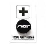 Round pinback button that says ATHEIST. White text on a black background